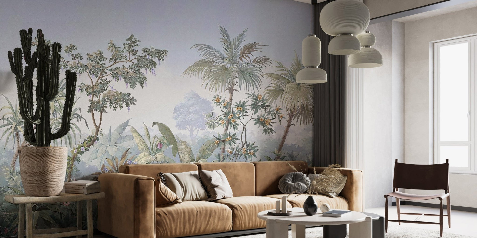 Tropical jungle wall mural behind a brown leather couch and potted cactus.