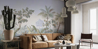 Tropical jungle wall mural behind a brown leather couch and potted cactus.