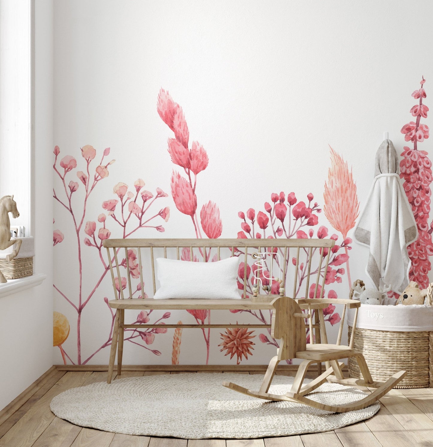 Pink botanical dried flower wall mural in a child's playroom with wooden toys.