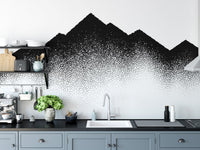 Dotted peak mural design on a kitchen backsplash wall with grey cabinets.