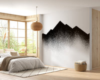 Dotted alpine wall mural behind a wooden bed frame in a bright bedroom.