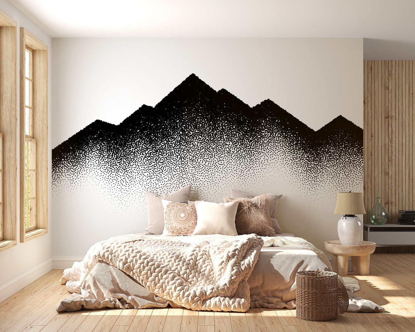 Monochrome dotted mountain wall mural above a beige upholstered bed with neutral pillows.