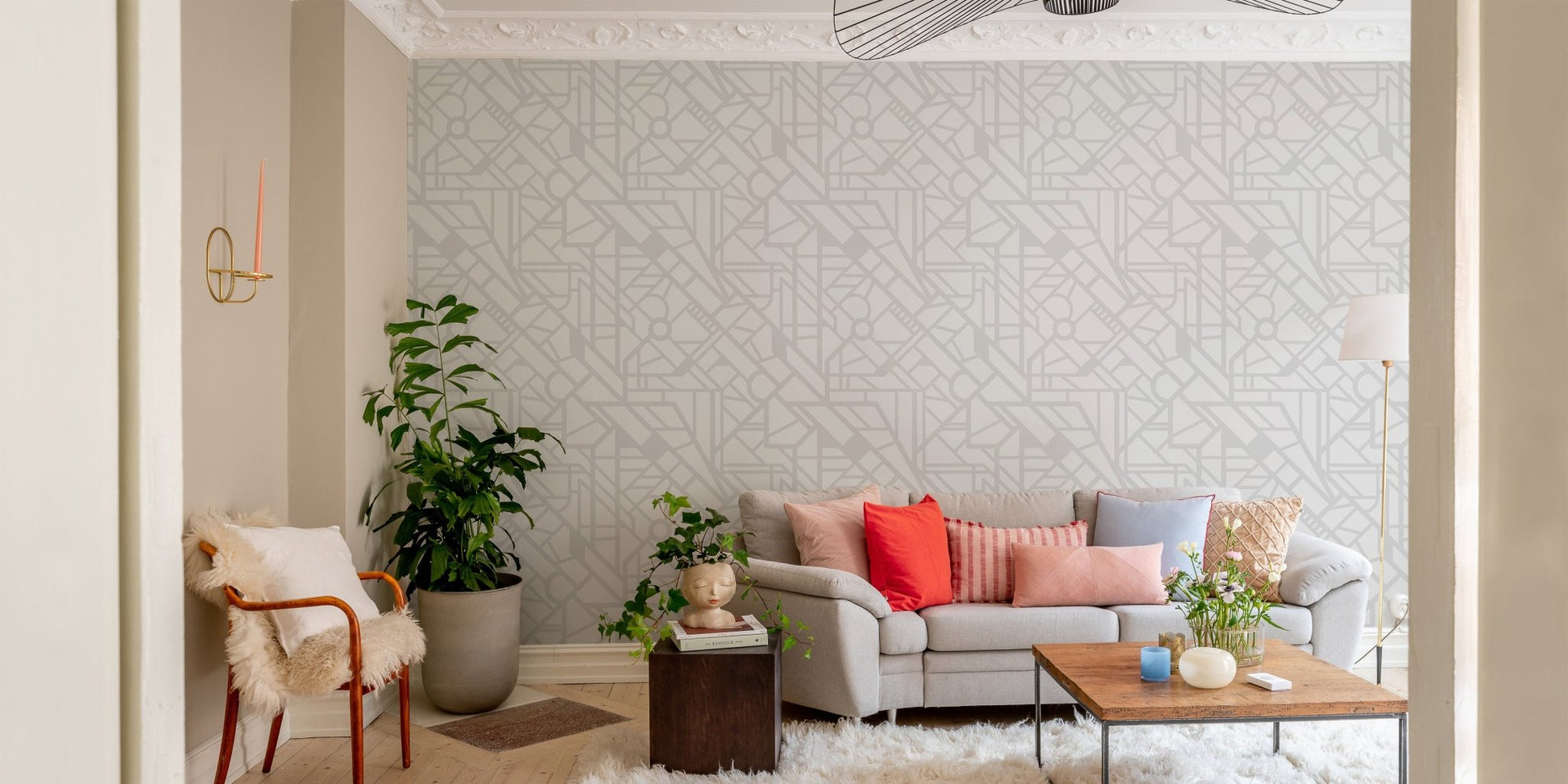 Light grey cityscape wallpaper in a living room with a grey sofa and green plants.