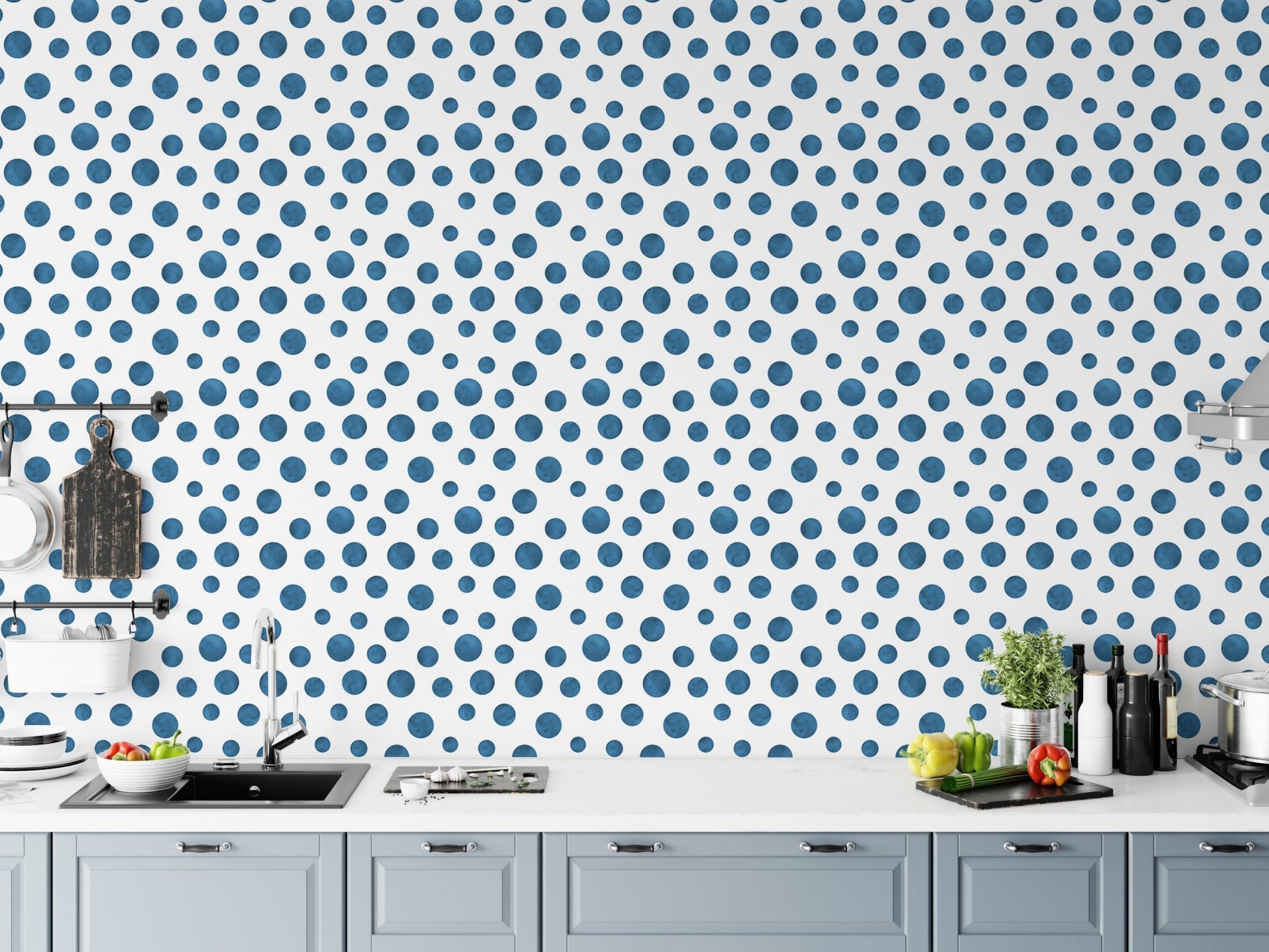 Indigo dotted wallpaper applied to a kitchen backsplash area with white cabinets.