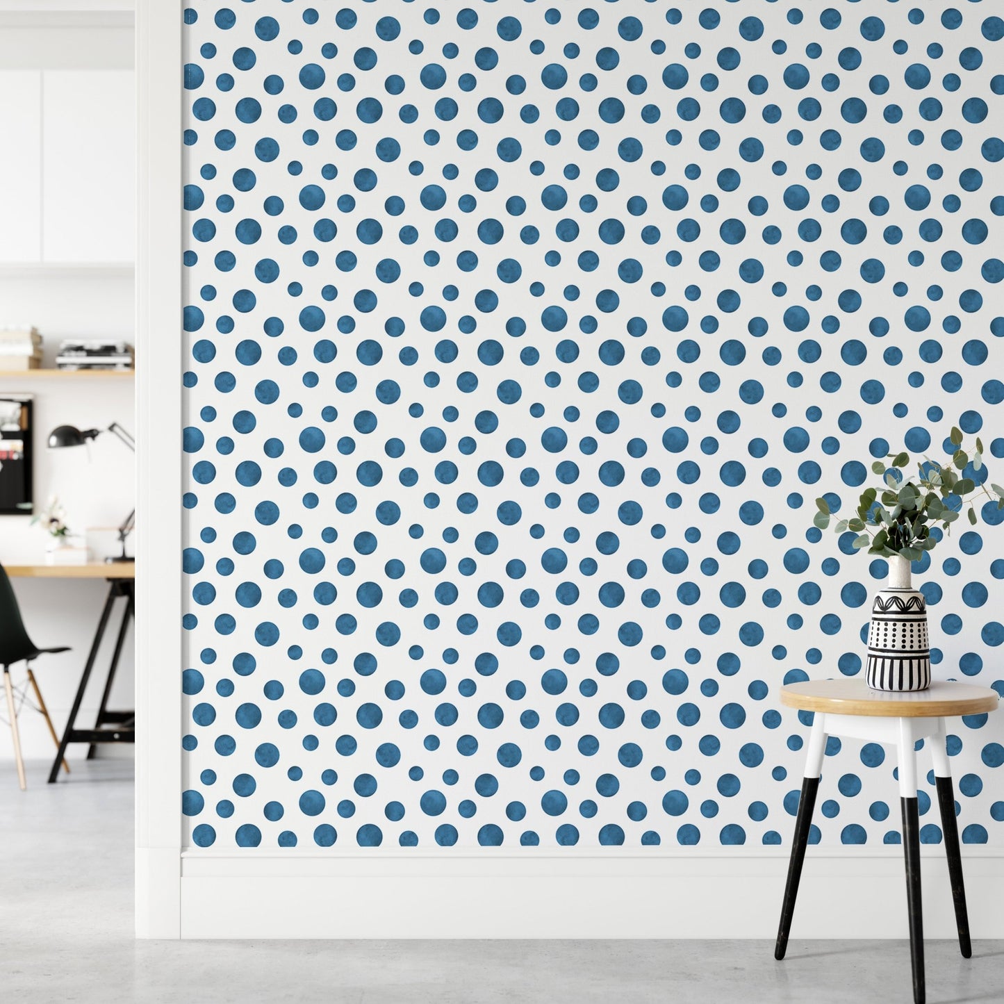 Blue watercolor circle wallpaper in a minimalist hallway with a small stool.