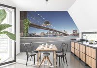 Urban skyline wall mural in a minimalist dining area with black chairs and wood table.