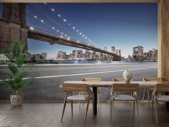 New York city mural on a dining room wall with light wood furniture and indoor plants.