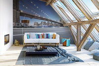 New York bridge wall mural behind a white sofa in a bright attic living room.
