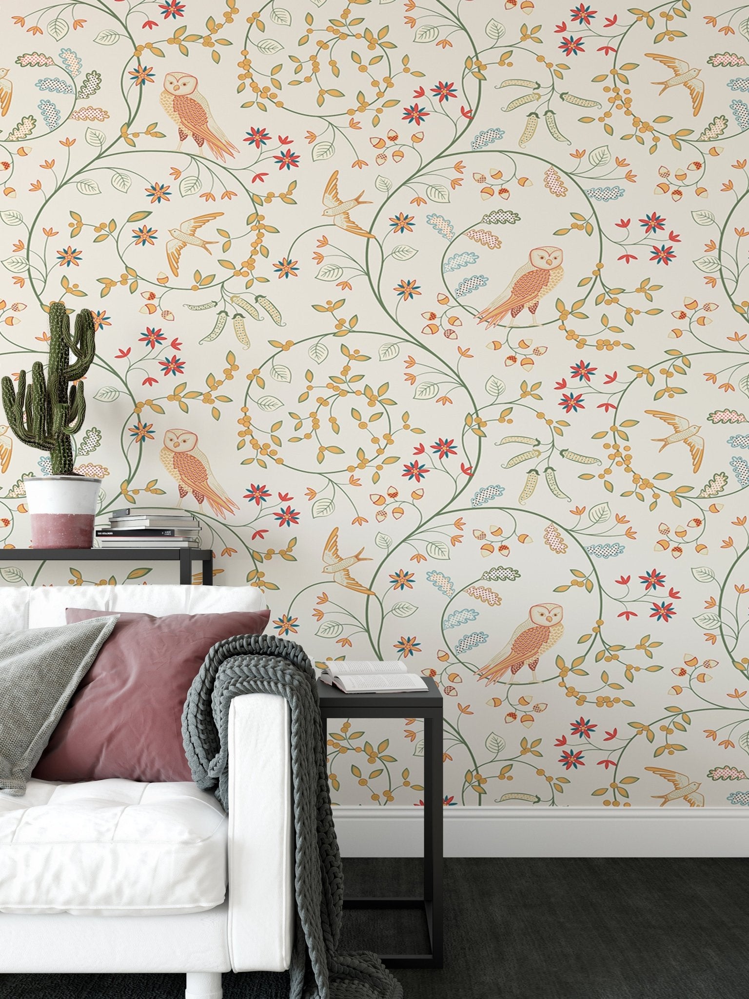 Floral wallpaper featuring russet and green vines behind a white sofa