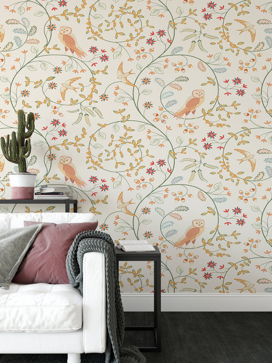 Floral wallpaper featuring russet and green vines behind a white sofa