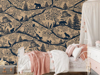 Beige and blue forest wall mural in a nursery with a white dresser and star pillows.