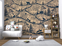 Beige woodland animal wall mural in a nursery with a white armchair and grey rug.