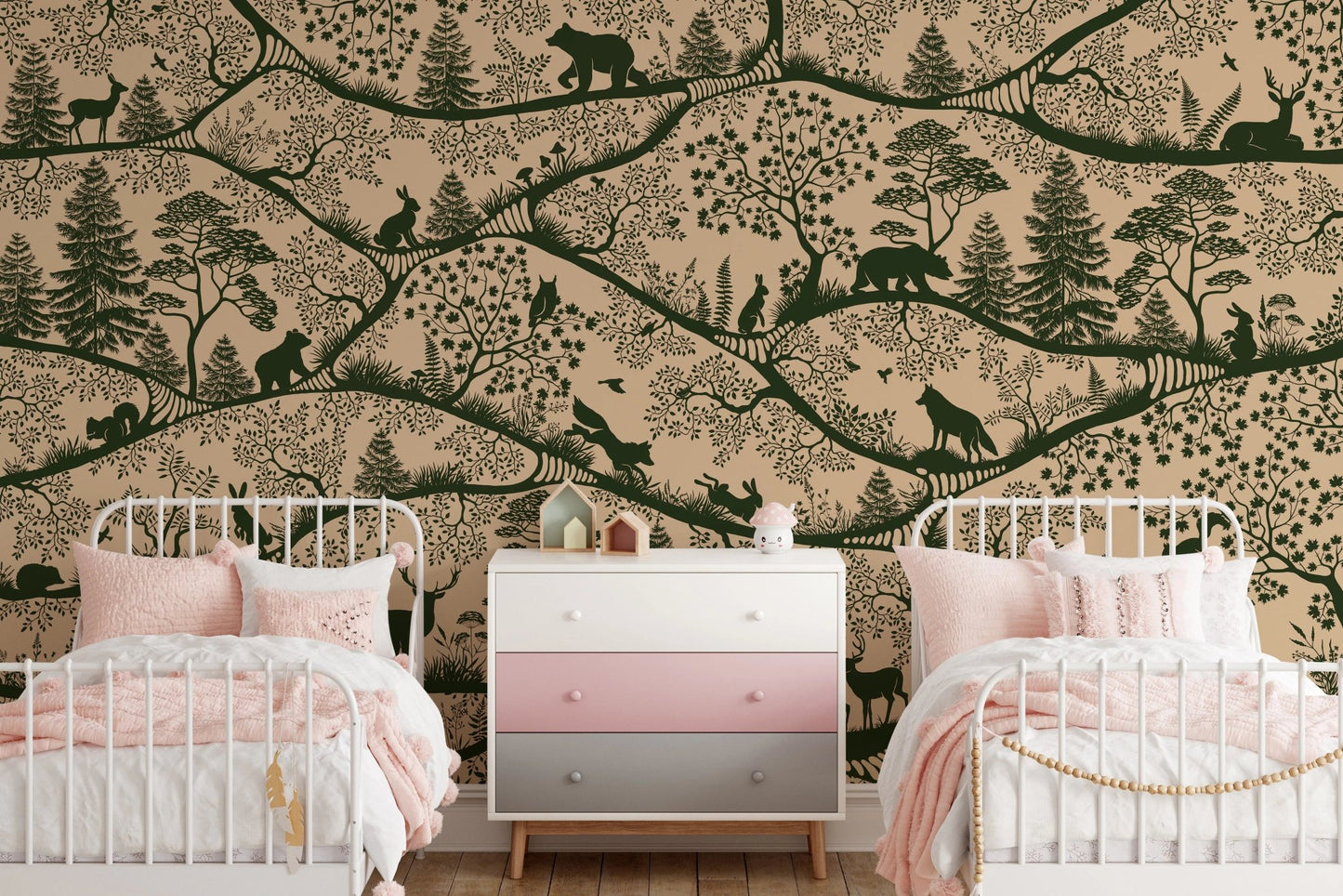 Twin beds with pink bedding set against a beige and green forest wall mural