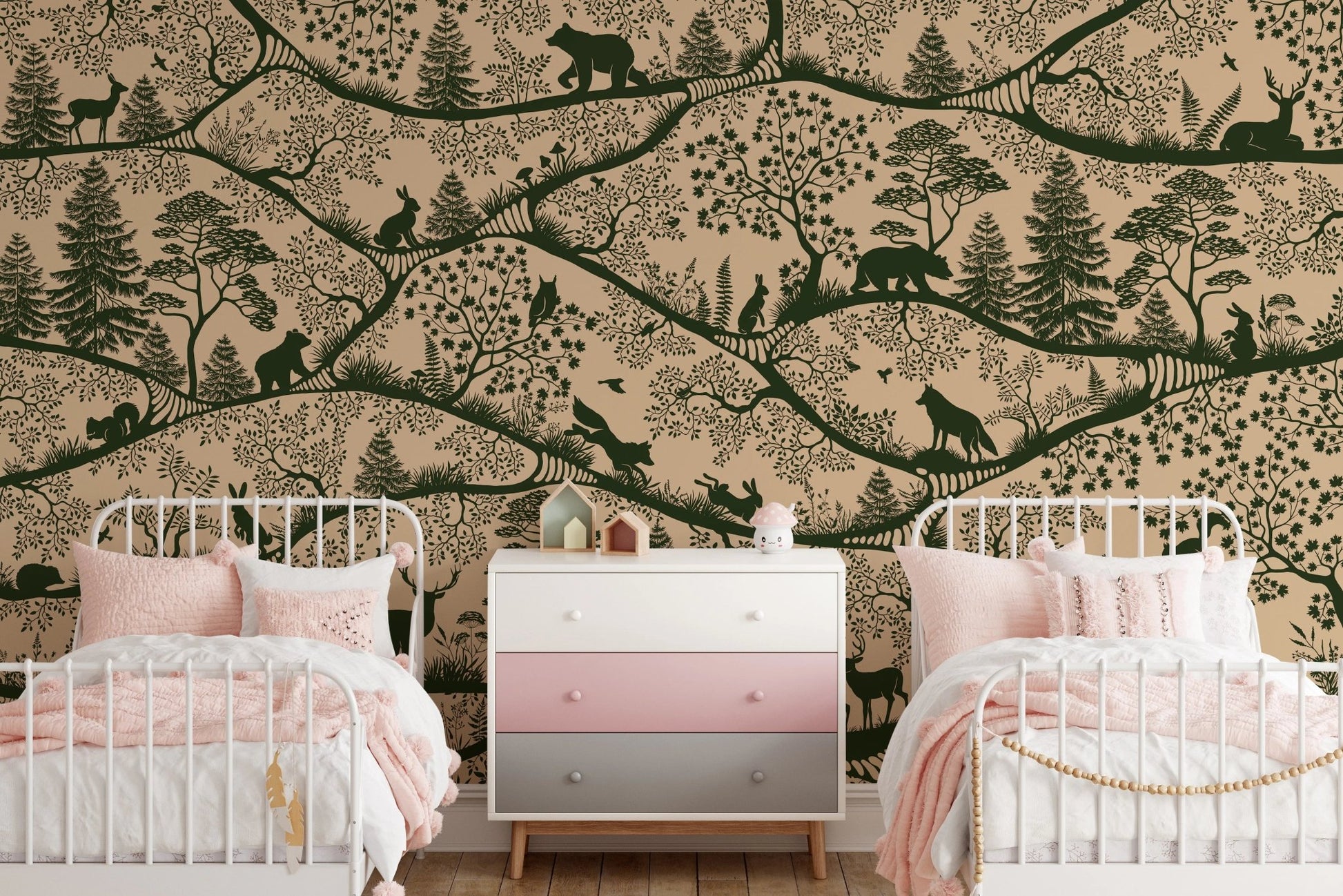 Twin beds with pink bedding set against a beige and green forest wall mural