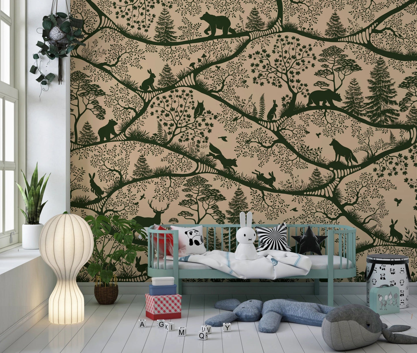 Nursery with a light blue metal crib and green forest animal wall mural