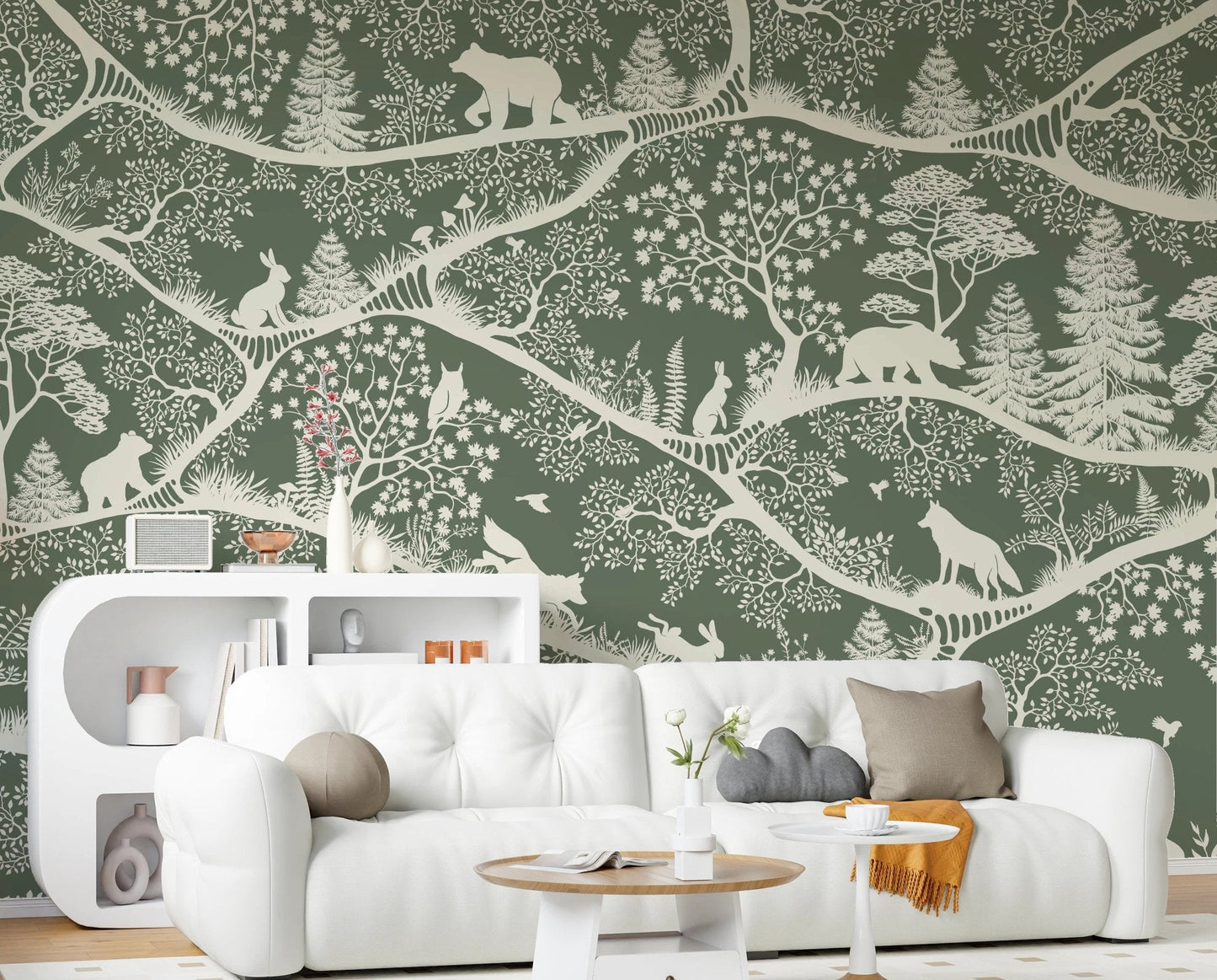 Green forest wall mural with bears and rabbits behind a white sofa in a living room.