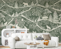 Green forest wall mural with bears and rabbits behind a white sofa in a living room.