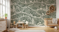 Green forest pattern wall mural in a neutral nursery with wooden furniture and toys.