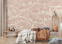 Detailed pink woodland animal wall mural behind a rustic wooden toddler bed.