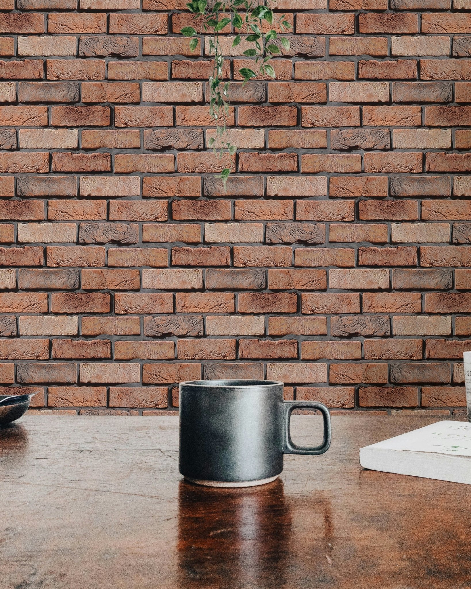 Detailed masonry wallpaper texture behind a dark ceramic mug on a wooden table