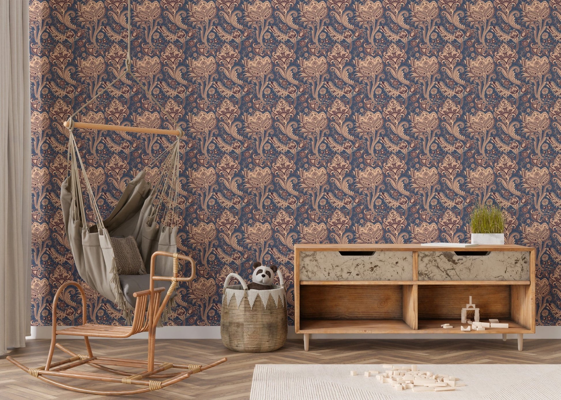 Vintage paisley wallpaper in nursery area with rattan hanging chair.