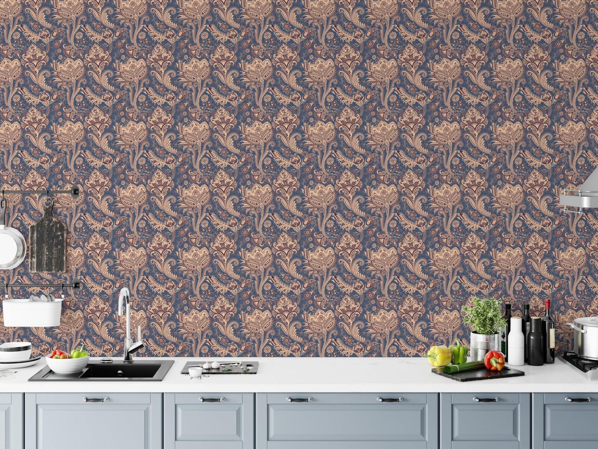 Vintage paisley wallpaper behind modern kitchen counter and white cabinets.