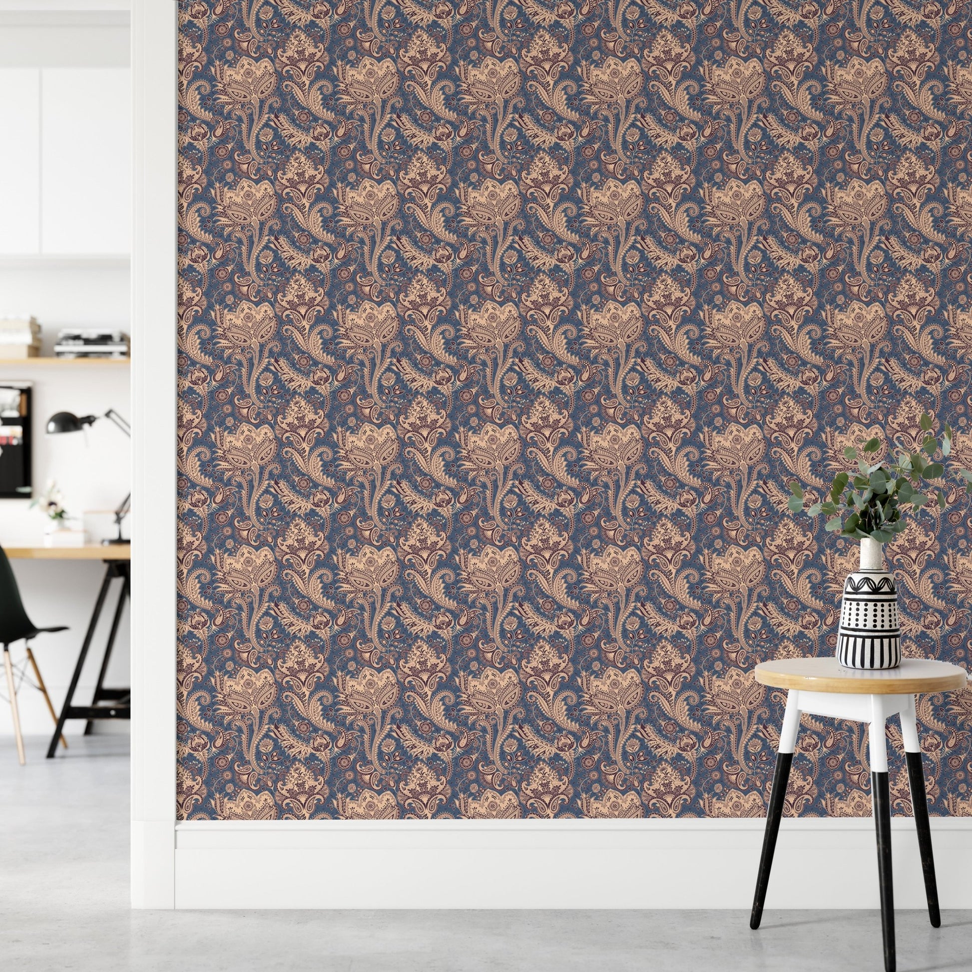 Indian floral pattern wallpaper in minimalist workspace with wooden stool.