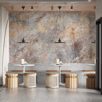 Industrial style concrete wall mural behind wooden stools in a modern restaurant.