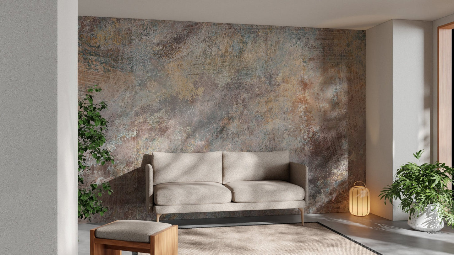 Weathered stone effect wall mural behind a grey couch in a minimalist living space.