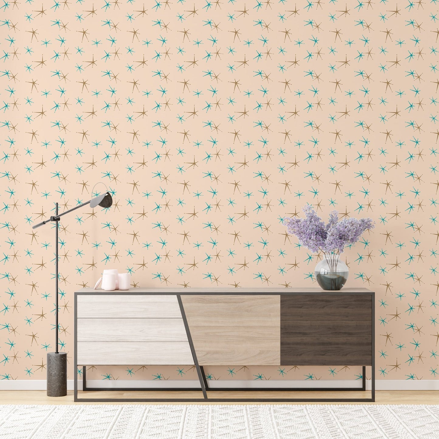 Retro atomic patterned wall mural as a backdrop for a grey and wood sideboard.