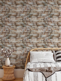 Textured sandstone wallpaper in a bedroom setting with white bedding.