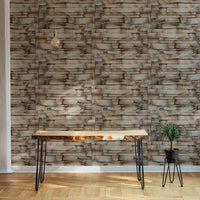 Realistic stone wallpaper behind a wooden desk in a home office setup.