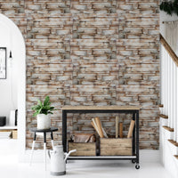 Neutral stone wallpaper in a hallway with a black metal console table.