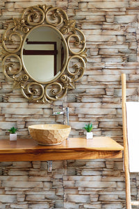 Vintage sandstone wallpaper used as a backdrop for a wooden vanity and mirror.