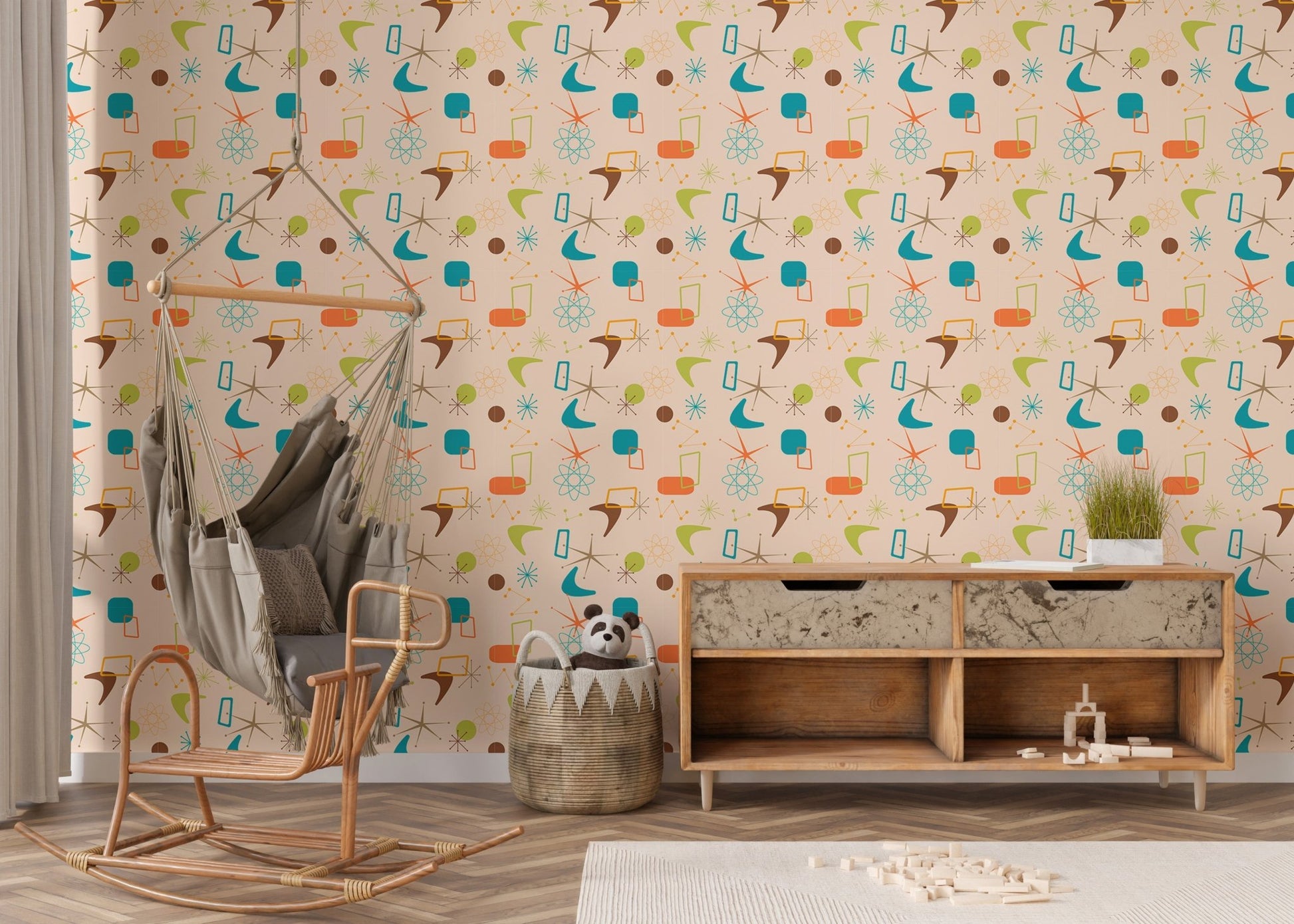 Nursery wall mural with a wooden rocking chair and atomic era geometric shapes.