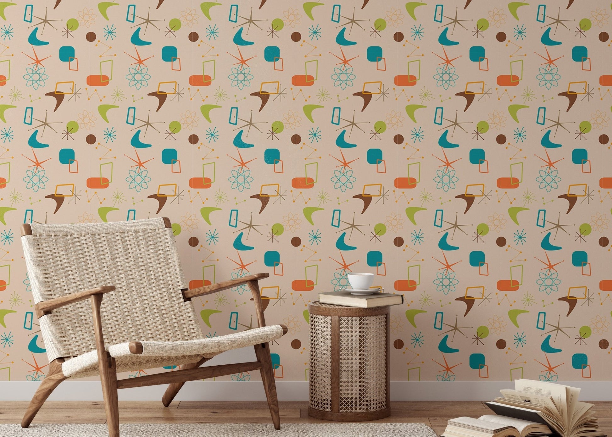 Reading area featuring a woven armchair against a vintage atomic pattern wall mural.