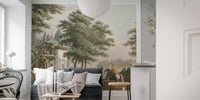 Vintage village wall mural behind black sofa and white pillars in minimalist room