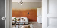 Minimalist wall mural featuring rust orange textured bottom and l grey top.
