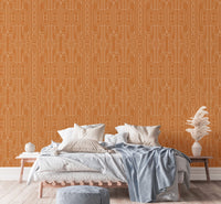Geometric linear wallpaper in a bedroom setting behind a white bed 
