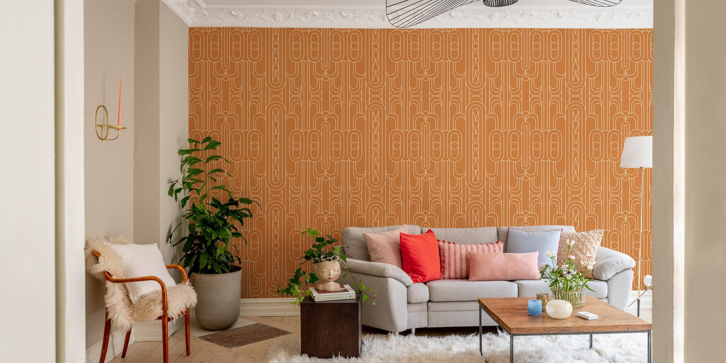 Textured orange wallpaper with white geometric lines behind a sofa in living area.