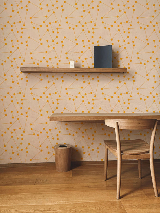 Orange shooting star geometric wall mural in a home office with wooden desk.