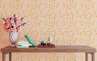 Geometric wall mural with orange lines in a reading area with floral decor.