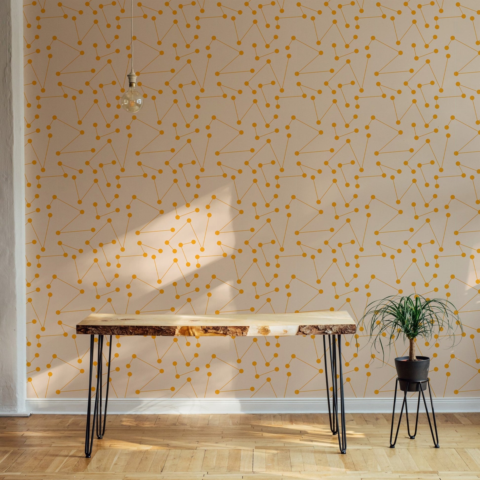 Minimalist orange pattern wall mural  behind a rustic wooden console table.
