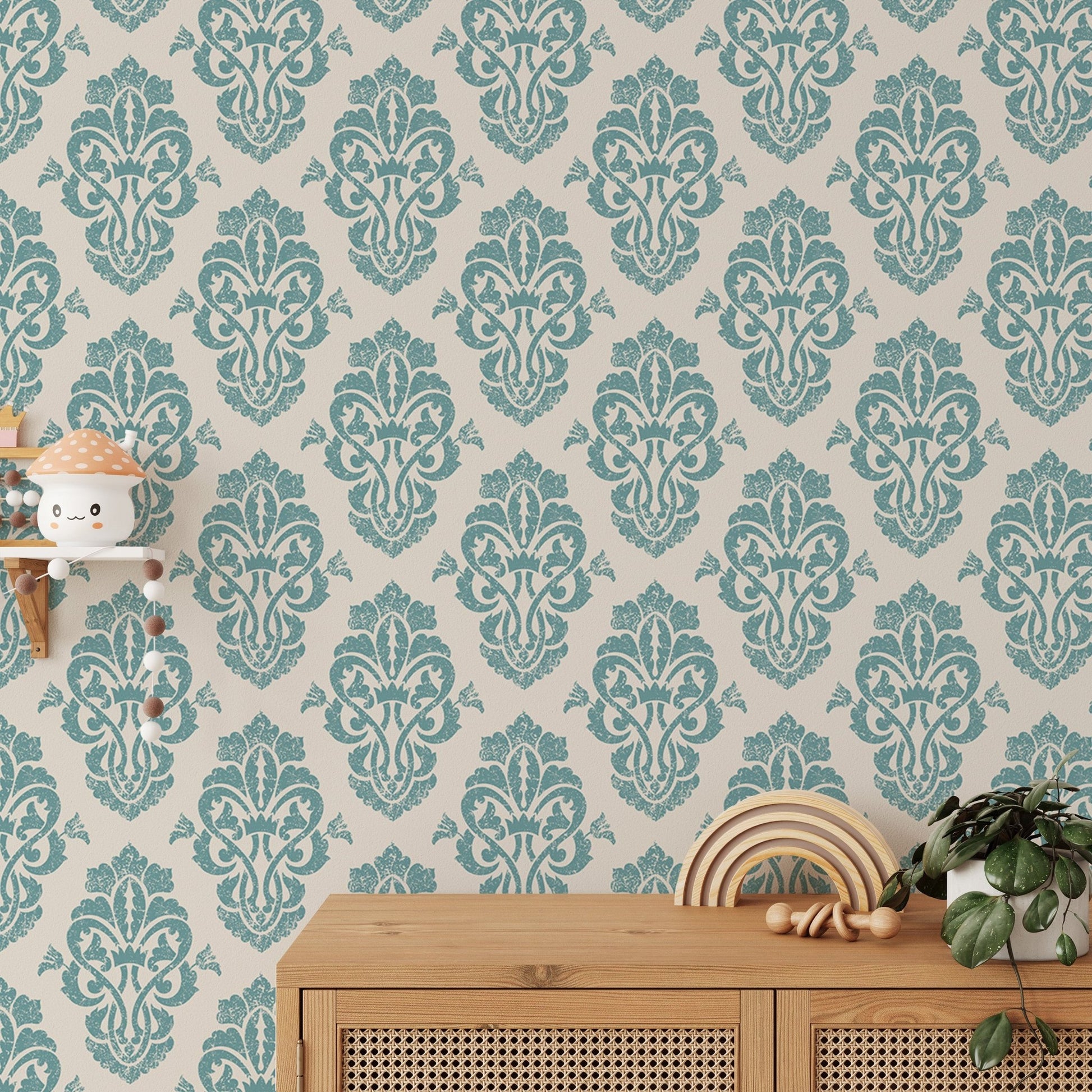 Ornamental damask wallpaper behind a wooden console table with plants.