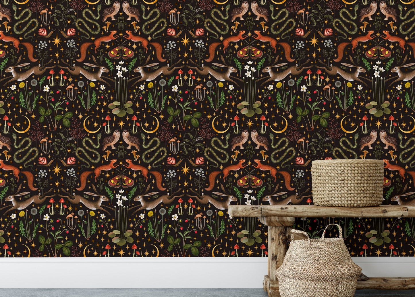 Wallpaper with dark floral patterns behind a wooden console table and baskets.