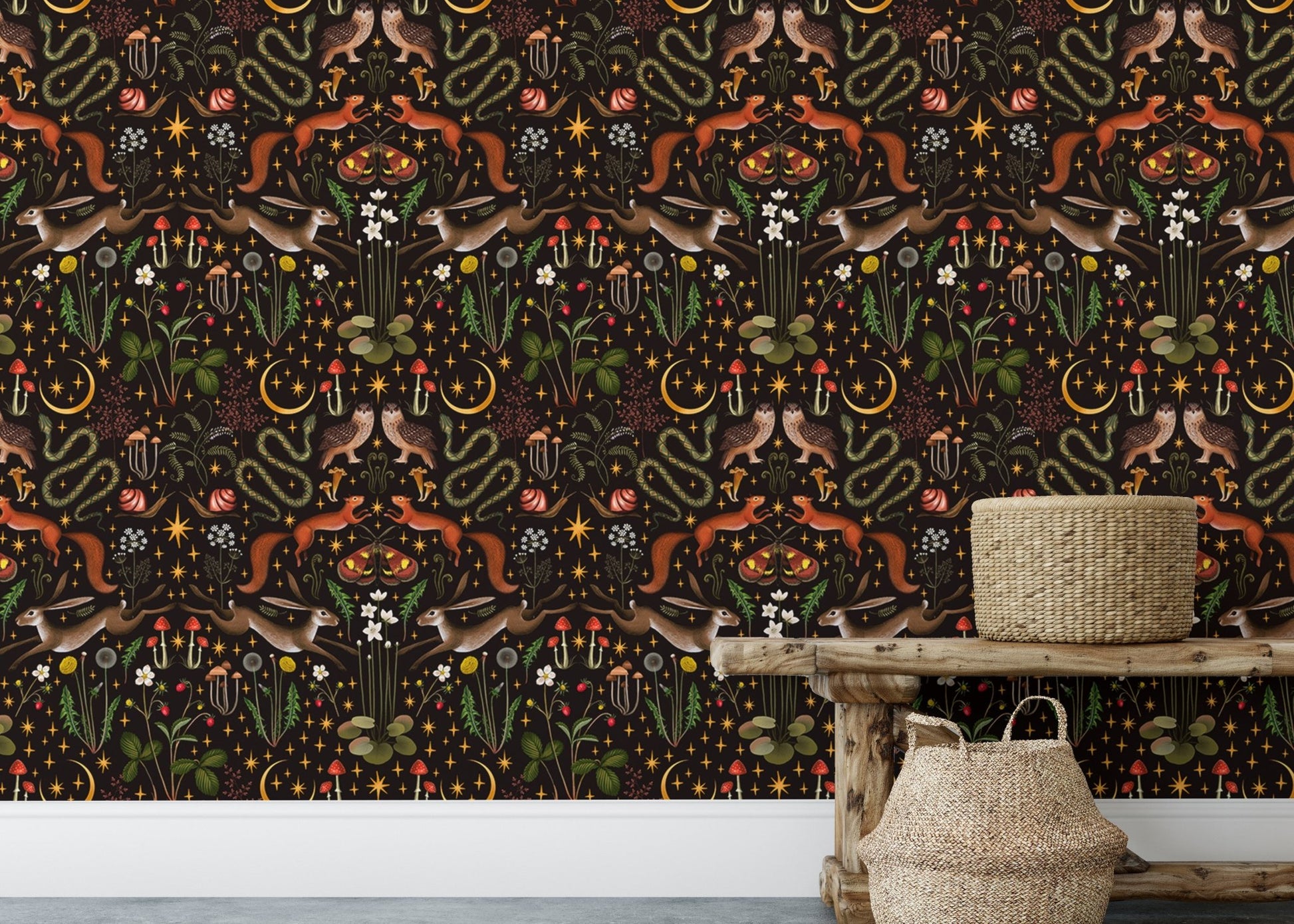 Wallpaper with dark floral patterns behind a wooden console table and baskets.