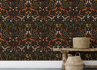 Wallpaper with dark floral patterns behind a wooden console table and baskets.