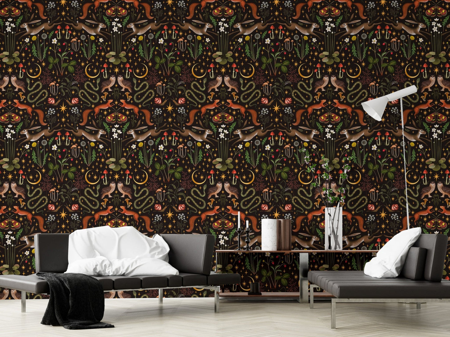 Symmetrical nature pattern wallpaper in a living area with a black sofa and lamp.