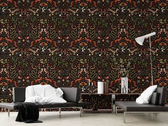 Symmetrical nature pattern wallpaper in a living area with a black sofa and lamp.