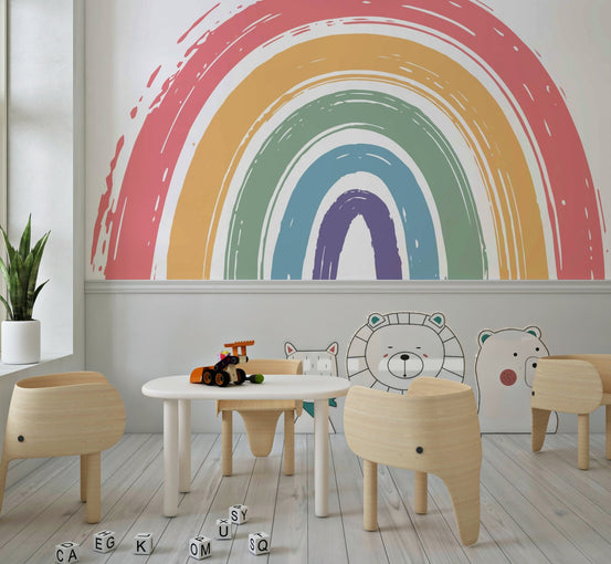 Hand painted rainbow arch wall mural in boho nursery style.